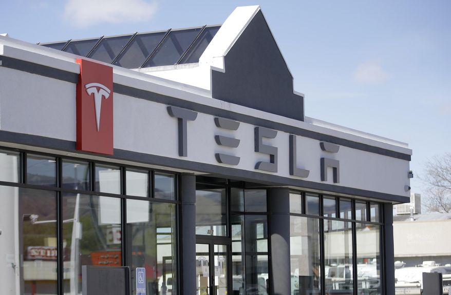 FILE - This April 1, 2015, file photo shows the Tesla Motors new showroom in Salt Lake City. New car dealers in Utah are fighting back against Tesla's Utah Supreme Court push to sell its sleek electronic cars in Utah, arguing that state laws were set up to protect customers and Tesla should have to follow them like everyone else. (AP Photo/Rick Bowmer, File)
