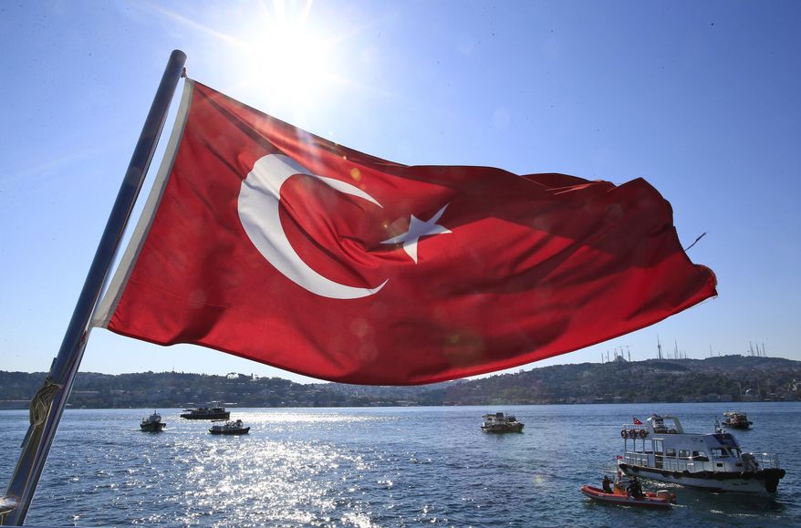 A Turkish flag flies near the Bosporus strait prior to the Bosporus Cross-Continental Swimming Race in Istanbul, Turkey, Sunday, July 24, 2016. More than 2,000 athletes are competing in the 6.5-kilometer challenging race. (AP Photo/Lefteris Pitarakis)