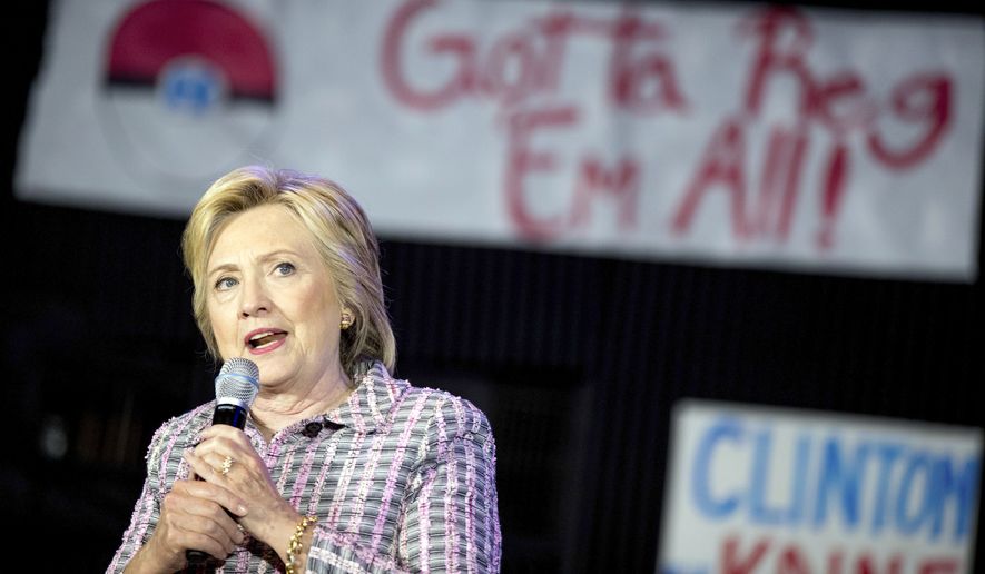 A Pokemon poster is visible behind Democratic presidential candidate Hillary Clinton as she speaks to volunteers at a Democratic party organizing event at the Neighborhood Theater in Charlotte, N.C., Monday, July 25, 2016. (AP Photo/Andrew Harnik)