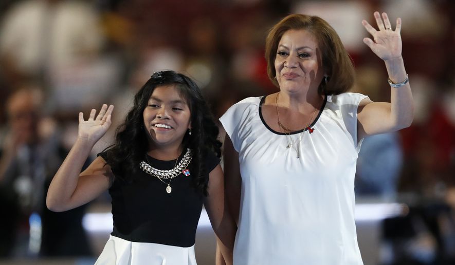 Karla Ortiz, 11, left, and her mother, Francisca Ortiz, wave after speaking during the first day of the Democratic National Convention on Monday in Philadelphia. (Associated Press)