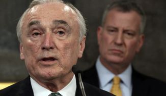 New York City Police Commissioner William Bratton (left) speaks during a news conference in New York&#39;s City Hall on Jan. 12, 2016, as New York Mayor Bill de Blasio listens. (Associated Press) **FILE**