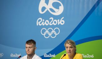 Australia&#39;s delegation head Kitty Chiller, right, and boxer Daniel Lewis listen to questions during a press conference in the Olympic Park in Rio de Janeiro, Brazil, Monday, July 25, 2016. The head of the Australian delegation says that despite a delay of several days she expects her delegation to move into the athletes village on Wednesday. (AP Photo/Felipe Dana)