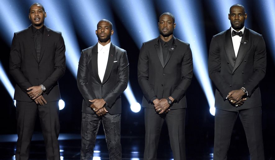 FILE - In this July 13, 2016, file photo, NBA basketball players Carmelo Anthony, Chris Paul, Dwyane Wade and LeBron James, from left, speak on stage at the ESPY Awards in Los Angeles. The four gave an anti-violence speech and expressed their support of the values behind the Black Lives Matter movement.(Photo by Chris Pizzello/Invision/AP, File)