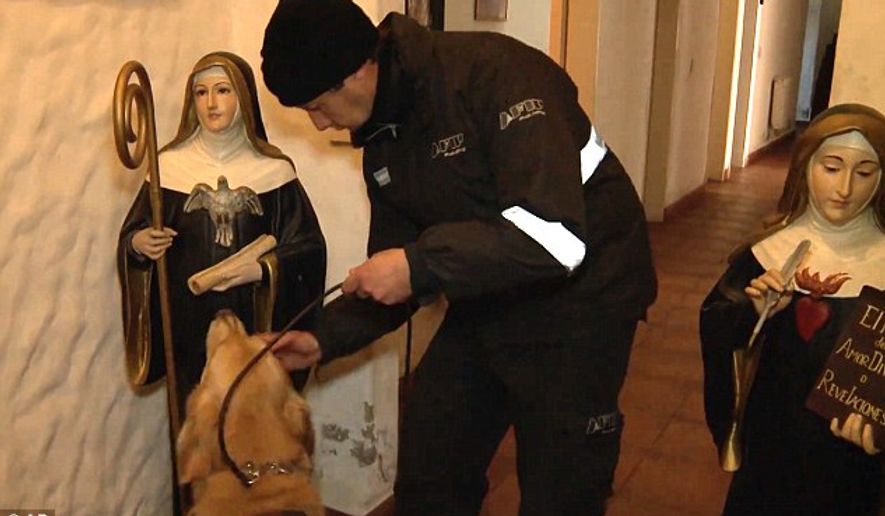 A police officer works with a K-9 inspecting the premises of Our Lady of the Rosary of Fatima monastery on the outskirts of Buenos Aires, Argentina. (Associated Press)