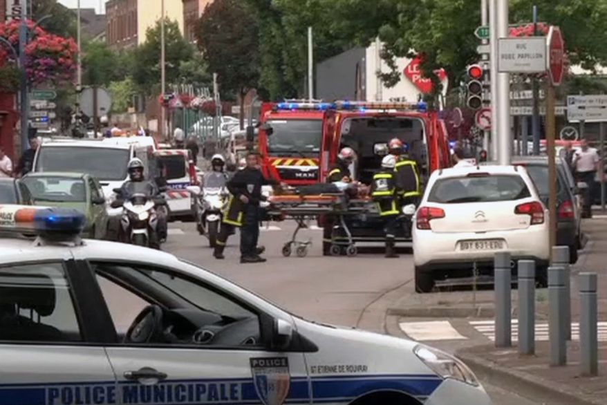 In this grab made from video, emergency services transport a person into a waiting ambulance in Normandy, France, Tuesday, July 26, 2016. Two attackers seized hostages in a church near the Normandy city of Rouen on Tuesday, killing one hostage by slitting their throat before being killed by police, a security official said. The identities of the attackers and motive for the attack are unclear, according to the official, who was not authorized to be publicly named. (BFM via AP)
