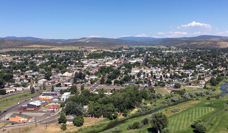 In this June 29, 2016, photo, the town of Prineville, Ore. is seen with the Ochoco National Forest on the horizon. (AP Photo/Andrew Selsky) **FILE**