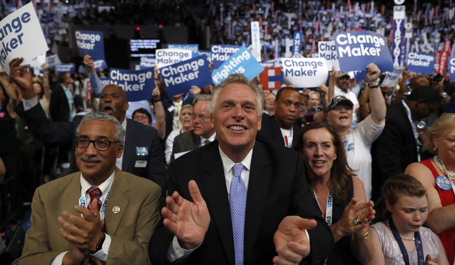 Virginia Gov. Terry McAuliffe applauds as Democratic Presidential candidate Hillary Clinton appears on the screen during the second day session of the Democratic National Convention in Philadelphia, Tuesday, July 26, 2016. (AP Photo/Carolyn Kaster)