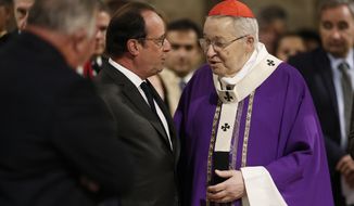 French President Francois Hollande speaks with French Archbishop of Paris Cardinal Andre Vingt-trois, right, before a mass to pay tribute to French priest Father Jacques Hamel at the Notre-Dame Cathedral in Paris, France, Wednesday, July 27, 2016. Father Jacques Hamel was killed on Tuesday in an attack on a church at Saint-Etienne-du-Rouvray near Rouen, Normandy, that was carried out by assailants linked to Islamic State. (Benoit Tessier/Pool Photo via AP)
