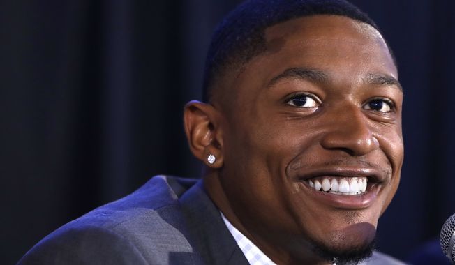 Washington Wizards guard Bradley Beal smiles during a news conference about his re-signing with the NBA basketball team, in Washington, Wednesday, July 27, 2016. (AP Photo/Jacquelyn Martin)
