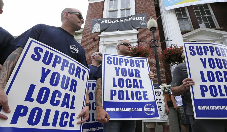 Police officers and their supporters picket outside Somerville City Hall, Thursday, July 28, 2016, in Somerville, Mass. Somerville Mayor Joe Curtatone is promising not to remove a Black Lives Matter banner from City Hall despite complaints from police officers in the state. (AP Photo/Charles Krupa)