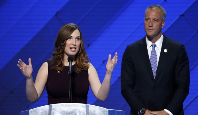LGBT rights activist Sarah McBride speaks as Rep. Sean Patrick Maloney, D-NY, Co-Chair of the Congressional LGBT Equality Caucus listens during the final day of the Democratic National Convention in Philadelphia , Thursday, July 28, 2016. (AP Photo/J. Scott Applewhite)