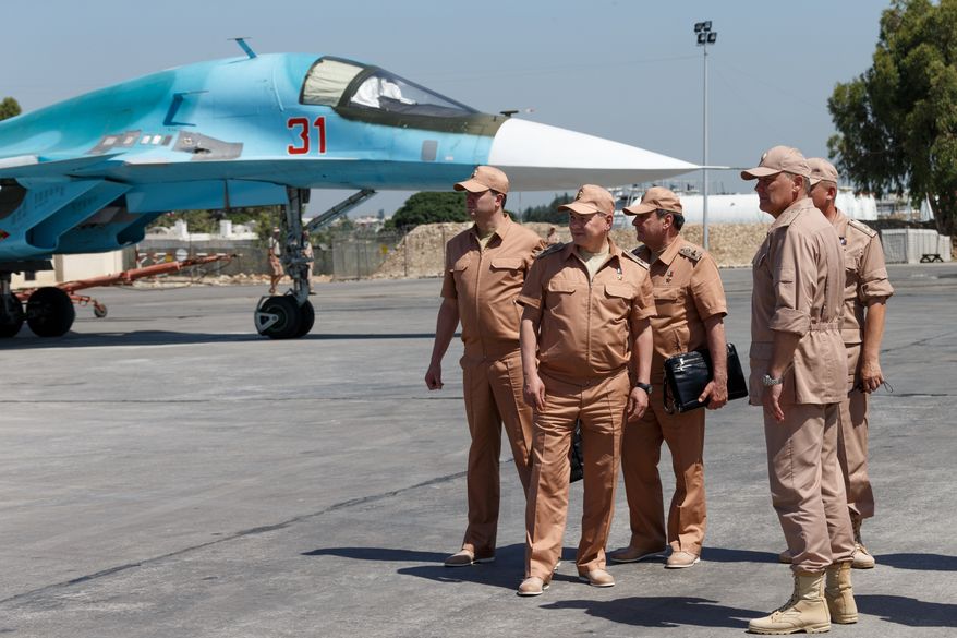 Russian Defense Minister Sergei Shoigu (second left) visits the Hemeimeem air base in Syria on June 18, 2016. Shoigu said on July 28, 2016, that Russia and the Syrian government will open humanitarian corridors and offer a way out for Islamic State fighters wanting to lay down their arms. (Vadim Savitsky/Russian Defense Ministry Press Service Pool Photo via AP) **FILE**