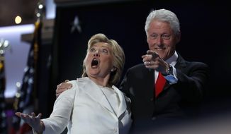 Democratic presidential nominee Hillary Clinton and former President Bill Clinton react as balloons fall during the final day of the Democratic National Convention in Philadelphia on July 28, 2016. (Associated Press) **FILE**