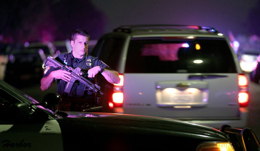 A San Diego Harbor Police officer helps to secure the scene near the corner of 39th Street and Boston Avenue in San Diego near where two San Diego Police officers were shot Thursday night, July 28, 2016. (John Gastaldo/The San Diego Union-Tribune via AP)