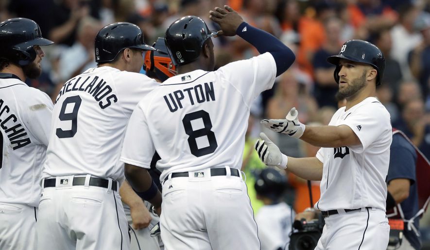 Detroit Tigers&#x27; Tyler Collins, right, is greeted at home plate by Jarrod Saltalamacchia, left, Nick Castellanos (9) and Justin Upton (8), after his three-run home run during the second inning of a baseball game against the Houston Astros, Friday, July 29, 2016, in Detroit. (AP Photo/Carlos Osorio)