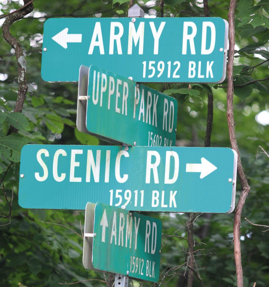 ADVANCE FOR USE SUNDAY, JULY 31, 2016 AND THEREAFTER - In this May, 2016 photo, a sign for Army Road is one of the few remaining clues to the existence of a former Nike missile base located in the middle of Pere Marquette State Park near Grafton, Ill. Fences and one or two remaining buildings are all that is left of the Nike missile facility. The base was one of more than 260 Nike missile facilities protecting the country from Russian bombers from the 1950s through the mid-1970s. (Scott Cousins/The Telegraph via AP)
