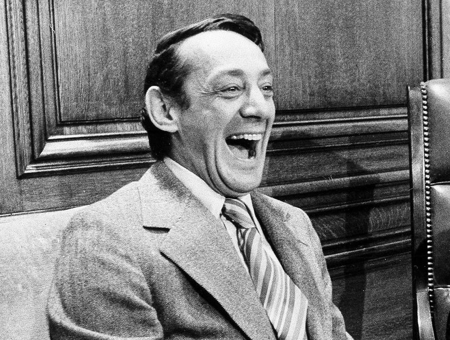 FILE - In this April 1977 file photo, San Francisco supervisor Harvey Milk sits in the mayor&#x27;s office during the signing of the city&#x27;s gay rights bill in San Francisco. The late gay rights leader Milk already has schools, streets and parks named in his honor. Soon, a U.S. Navy ship will join the list. A Navy official said Friday, July 29, 2016, that Navy Secretary Ray Mabus notified Congress earlier this month that a new fleet of replenishment oilers being built in San Diego will be named for Milk and five other civil and human rights icons. (AP Photo/File)