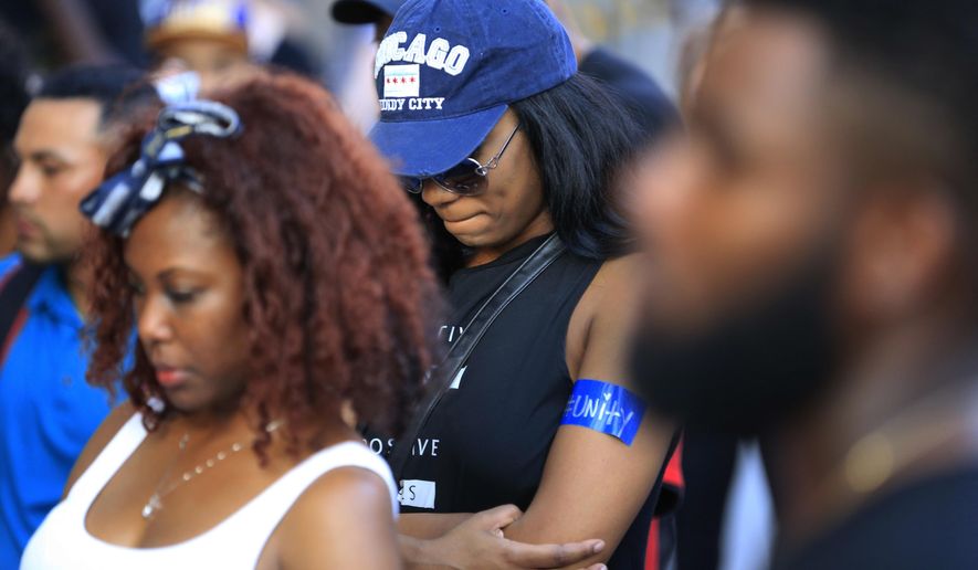Protestors stop for a prayer during a march Friday, July 29, 2016, in Dallas. The event was organized by the same activist group that organized the July 7, protest that ended with the fatal shooting of multiple police officers. (AP Photo/Ron Jenkins)