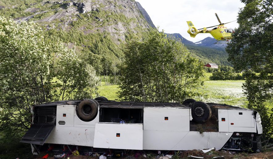 The wreckage of a bus is seen in Valldal, near Geiranger, on the south west coast of Norway, Saturday, July 30, 2016. One person was killed and two people were seriously injured Saturday when a tourist bus skidded off the road and into a ravine in Norway, police and a rescue official said. The bus was en route to Trollstigen, a steep road with a dozen of hairpin turns that leads to the Geirangerfjord, one of Norway&#x27;s most visited tourist sites, when it fell into a ravine, rescue spokesman Tor Ivar Sjaastad. (Svein Ove Ekornesvag/NTB Scanpix via AP)