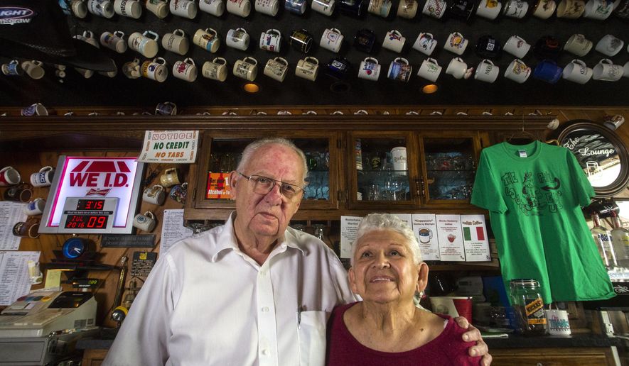 ADVANCE FOR SUNDAY JULY 31 - In this Saturday, July 9, 2016 photo, Bar owners Phil and Mary Love stand behind the bar at The Lounge in Dubuque, Iowa. The Lounge opened the space in 1980 and are known as legends in the town. It hasn't changed much. (Adam Warner/Telegraph Herald via AP)