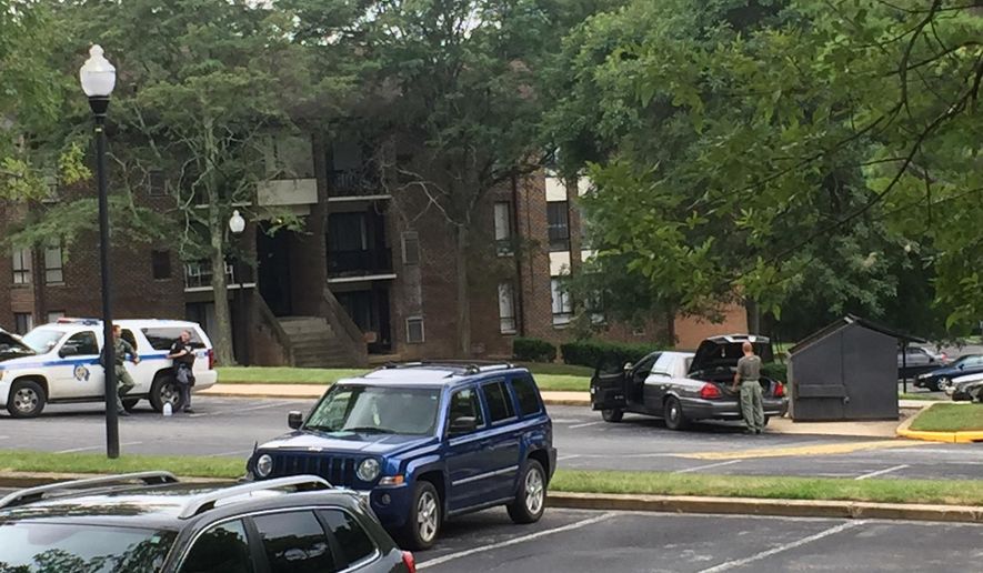 Authorities respond to the scene Randallstown, Md., Monday, Aug. 1, 2016. Baltimore County police say officers have shot and killed a woman who barricaded herself and a child inside a suburban Baltimore apartment and pointed a gun at them. (Maya Earls/The Baltimore Sun via AP)
