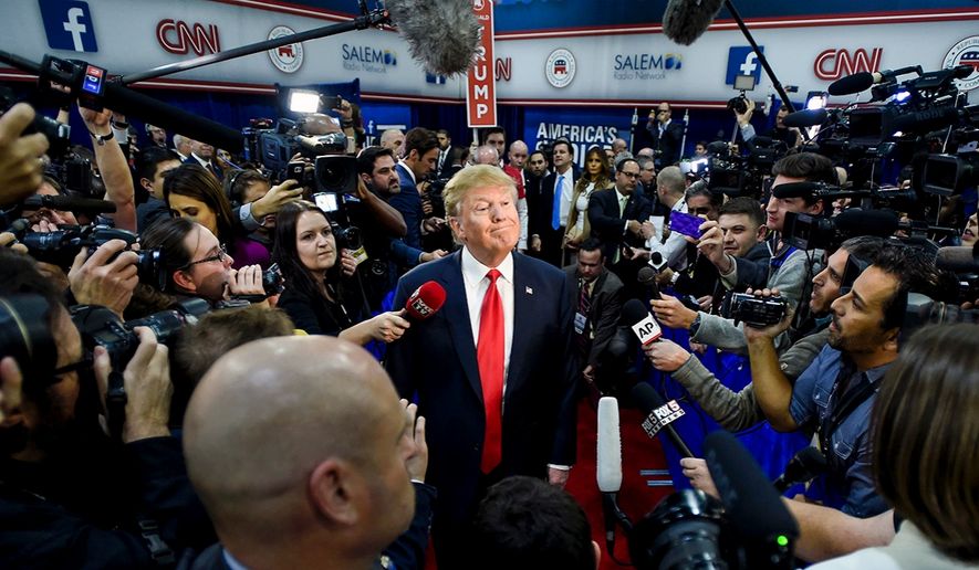 President Trump is surrounded by the news media while on the campaign trail, seen here in a stop in Las Vegas.    (Associated Press)