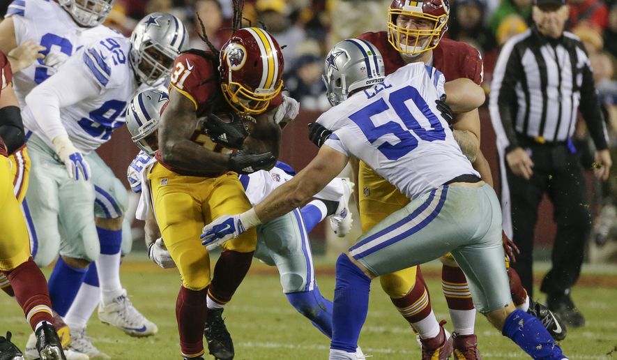 Washington Redskins running back Matt Jones (31) carries the ball past Dallas Cowboys outside linebacker Sean Lee (50) during the first half of an NFL football game in Landover, Md., Monday, Dec. 7, 2015. (AP Photo/Mark Tenally)
