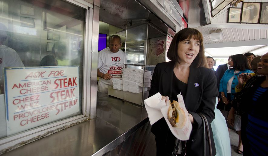 Democratic National Committee (DNC) CEO Amy Dacey and other representatives considering where to host the 2016 convention, get cheesesteaks at Pat&#39;s King of Steaks in Philadelphia on Wednesday, Aug. 13, 2014. Philadelphia is one of five cities bidding to host the convention along with Birmingham, Ala; Columbus, Ohio; the Brooklyn borough of New York, and Phoenix.  (AP Photo/Matt Rourke)