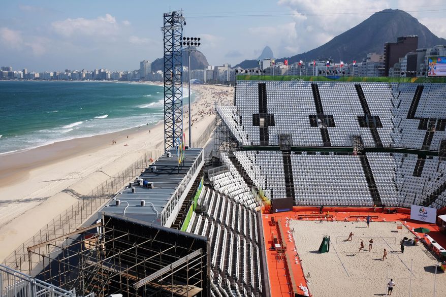 Beach volleyball players practice on center court of the beach volleyball arena along Copacabana Beach ahead of the upcoming 2016 Summer Olympics in Rio de Janeiro, Brazil, Tuesday, Aug. 2, 2016. (AP Photo/David Goldman)