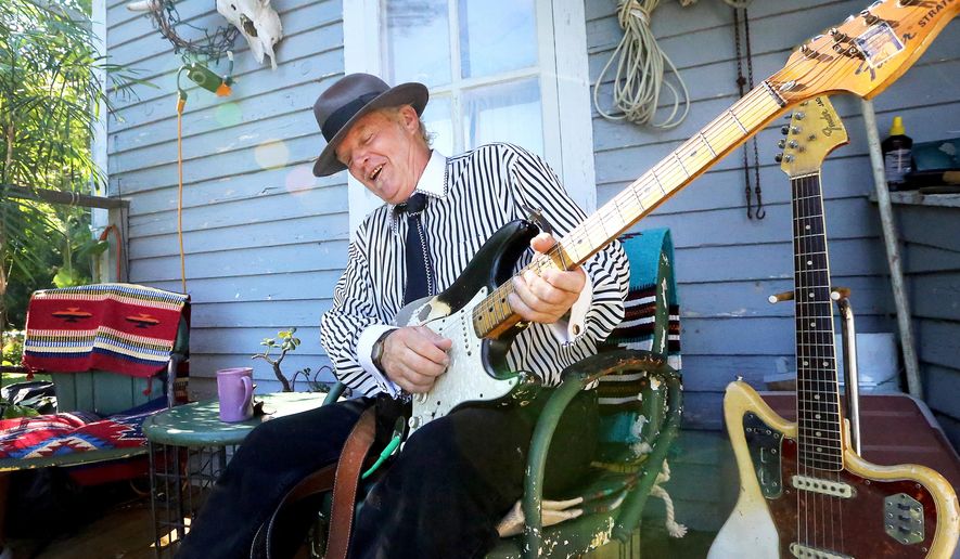 Blues musician Paul Filipowicz plays on the porch of his home in Aztalan, Wis., on July 26, 2016. Whether it's at the Badger Bowl in Madison, an American Legion beer tent in Lake Mills or Buddy Guy's Legends in Chicago, Filipowicz, who makes his home just east of the Crawfish River in Jefferson County, goes into each show hoping to knock his fans off their feet and leave them gasping for air. (John Hart/Wisconsin State Journal via AP)