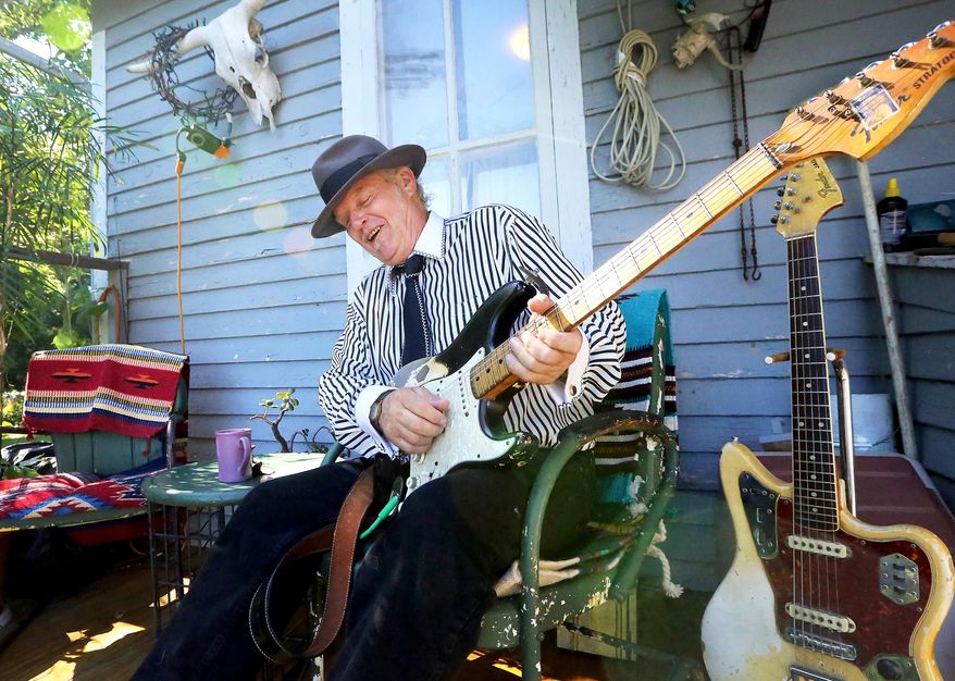 Blues musician Paul Filipowicz plays on the porch of his home in Aztalan, Wis., on July 26, 2016. Whether it's at the Badger Bowl in Madison, an American Legion beer tent in Lake Mills or Buddy Guy's Legends in Chicago, Filipowicz, who makes his home just east of the Crawfish River in Jefferson County, goes into each show hoping to knock his fans off their feet and leave them gasping for air. (John Hart/Wisconsin State Journal via AP)