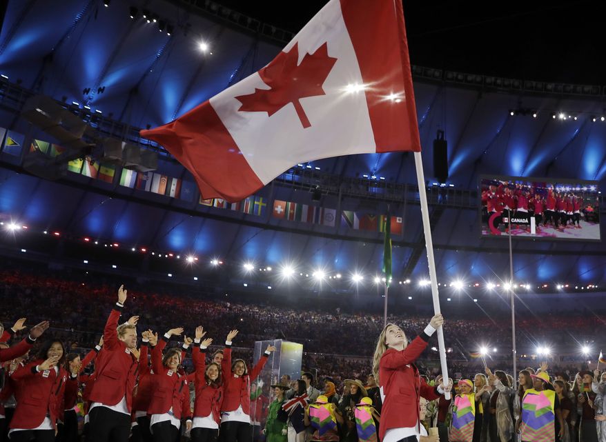 Rosannagh Maclennan carries the flag of Canada during the opening ceremony for the 2016 Summer Olympics in Rio de Janeiro, Brazil, Friday, Aug. 5, 2016. (AP Photo/David J. Phillip) ** FILE **