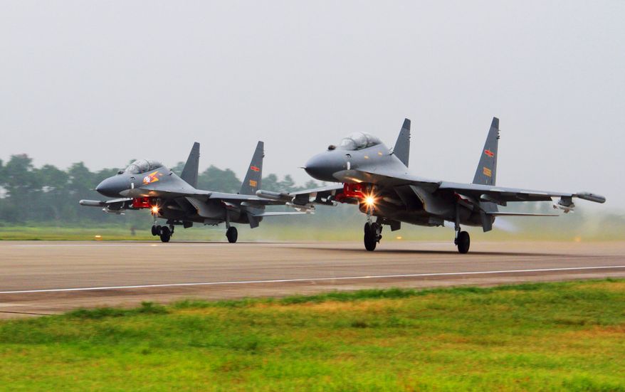 In this undated photo released Saturday, Aug. 6, 2016, by China's Xinhua News Agency, two Chinese Su-30 fighter jets take off from an unspecified location to fly a patrol over the South China Sea. China's air force announced Saturday that it has conducted a combat air patrol over disputed areas of the South China Sea. (Jin Danhua/Xinhua via AP)
