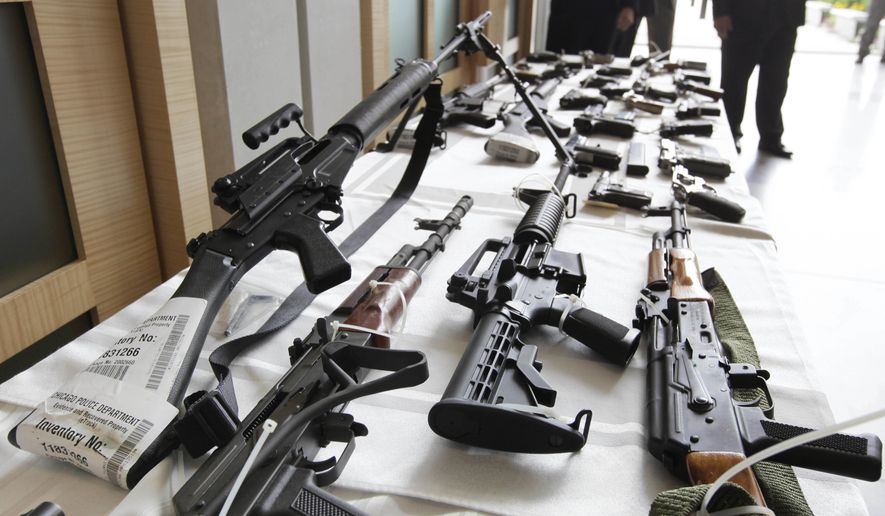 Various guns are displayed at the Chicago FBI office in this July 22, 2010, file photo. (AP Photo/M. Spencer Green, File) **FILE**