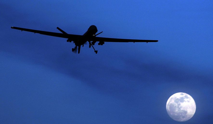 In this Jan. 31, 2010, file photo, an unmanned U.S. Predator drone flies over Kandahar Air Field, southern Afghanistan, on a moon-lit night. The White House has a released a version of President Barack Obama’s three-year-old directive on the use of lethal force against terrorists overseas, laying out what it says are safeguards to minimize civilian deaths and errant strikes while preserving the capability to take quick action with drone attacks and other means.(AP Photo/Kirsty Wigglesworth, File)