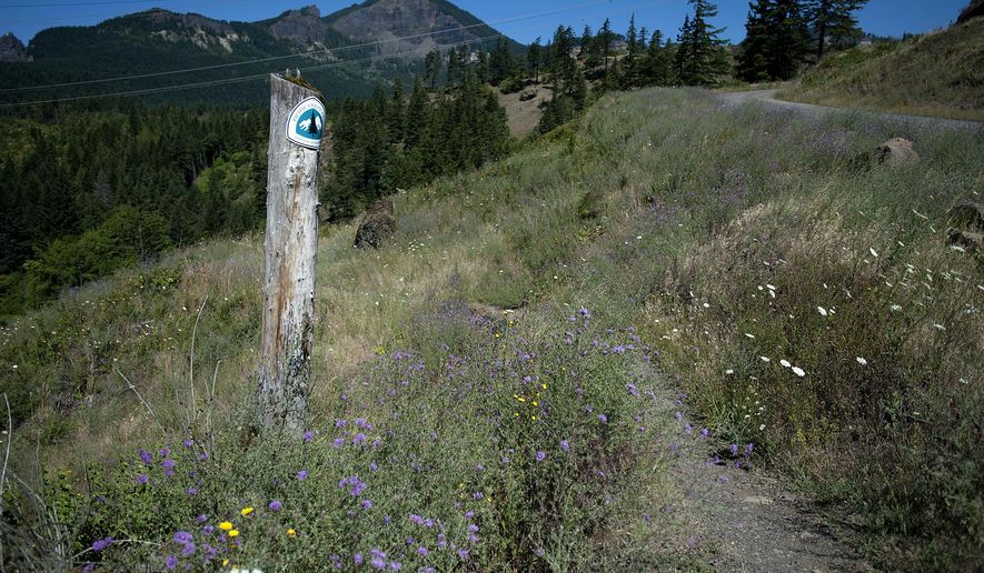 ADVANCE FOR THE WEEKEND OF AUG. 6-7 AND THEREAFTER - In a July 14, 2016 photo, a marker for the Pacific Crest Trail, which runs through Ted Salka's property, is seen in North Bonneville, Wash.. Salka's plans to sell some of his land to the U.S. Forest Service has frustrated local officials. (Amanda Cowan/The Columbian via AP)