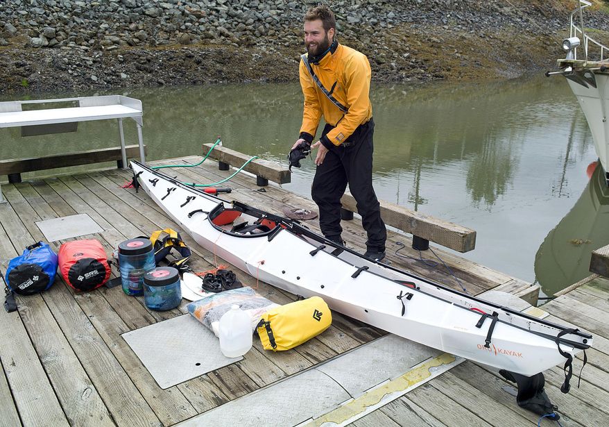 ADVANCE FOR RELEASE SATURDAY, AUG. 6, 2016 AND THEREAFTER In this July 25, 2016 photo, Austin Jones unpacks his foldable kayak in Juneau, Alaska, after finishing a trip from Anacortes, Washington, to Juneau. Jones' "origami kayak," as the manufacturer's website puts it, looks like it's made out of corrugated cardboard, something more suited to campaign signs than open seas. (Michael Penn/Juneau Empire via AP)