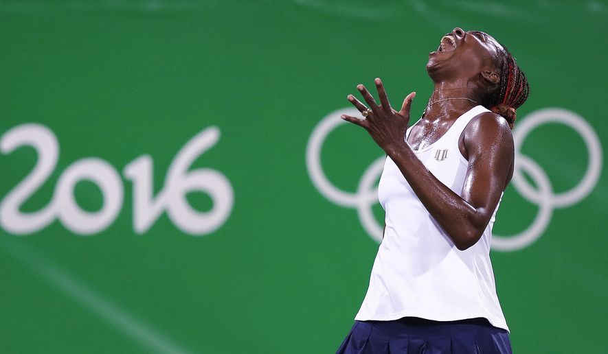 CORRECTS SPELLING OF LAST NAME TO SAFAROVA INSTEAD OF SARFAROVA - Venus Williams, of the United States, reacts after losing a point in a doubles match with her sister Serena against Lucie Safarova and Barbora Strycova, of the Czech Republic, at the 2016 Summer Olympics in Rio de Janeiro, Brazil, Sunday, Aug. 7, 2016. (AP Photo/Charles Krupa)