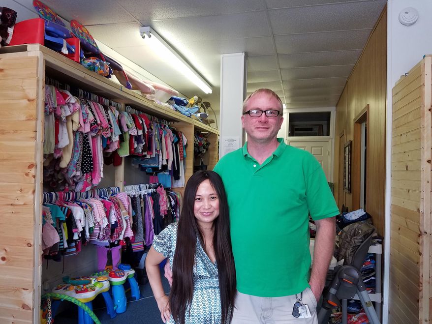 FOR RELEASE SUNDAY, AUGUST 7, 2016, AT 9:00 A.M. EDT.- In this photo taken July 27, 2016, in White Hall, W. Va., Hanzel and Brian Henline stand in their children's shop, John Angelos, in White Hall which they opened in memory of their son. (Kelsie Vanderwijst/Times West Virginian, via AP)
