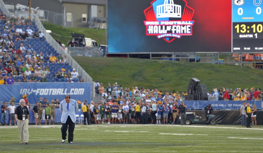 Pro Football Hall of Fame President and Executive Director David Baker, right, and Executive Vice President Joe Horrigan inspect the field moments before announcing that the preseason NFL football game between the Green Bay Packers and the Indianapolis Colts at Tom Benson Hall of Fame Stadium was cancelled due to unsafe field conditions, Sunday, Aug. 7, 2016, in Canton, Ohio. (AP Photo/David Richard)