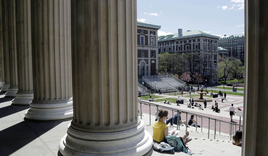 Students sit on the steps of Columbia University&#39;s Low Memorial Library in New York on April 29, 2015. (Associated Press) **FILE**