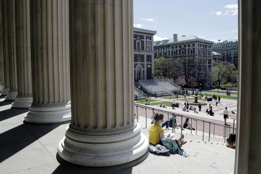 Students sit on the steps of Columbia University's Low Memorial Library in New York on April 29, 2015. (Associated Press) **FILE**