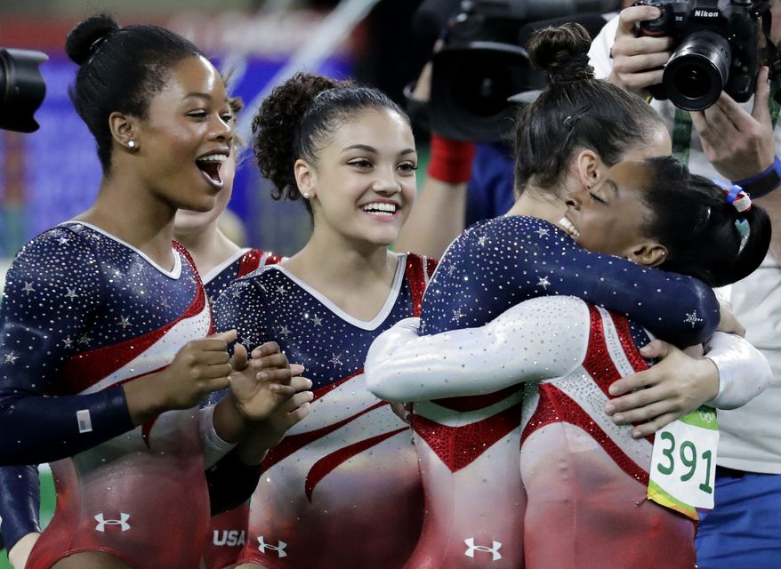 U.S. gymnasts, left to right, Gabrielle Douglas, Lauren Hernandez, Aly Raisman and Simone Biles celebrate at the end of the artistic gymnastics women&#39;s team final at the 2016 Summer Olympics in Rio de Janeiro, Brazil, Tuesday, Aug. 9, 2016.(AP Photo/Charlie Riedel)