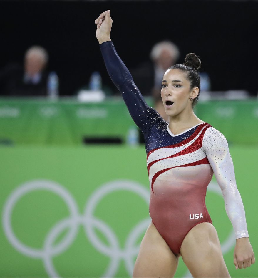 United States' Aly Raisman celebrates after her performance on the floor during the artistic gymnastics women's team final at the 2016 Summer Olympics in Rio de Janeiro, Brazil, Tuesday, Aug. 9, 2016. (AP Photo/Charlie Riedel)
