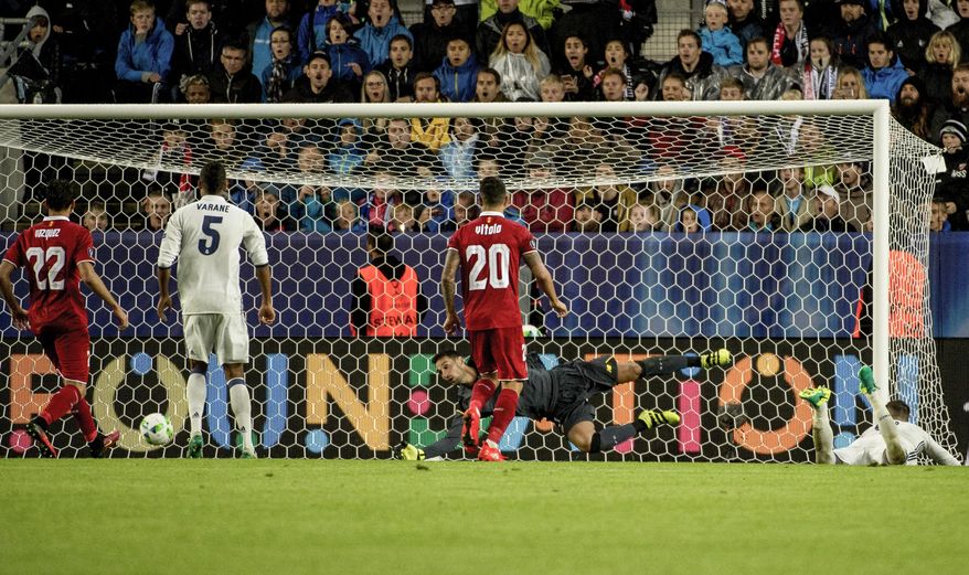 Real Madrid's Sergio Ramos, right, scores a goal, which was cancelled, against Sevilla during the Super Cup 2016 soccer match in Trondheim, Norway, Tuesday Aug. 9, 2016. (Ned Alley / NTB scanpix via AP)