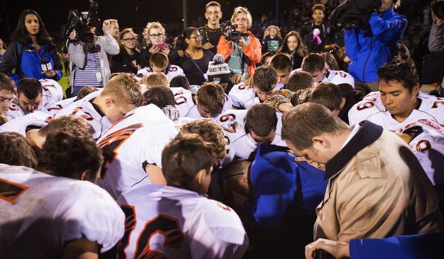 Coach Joe Kennedy started praying after games when he was hired as an assistant varsity football coach at Bremerton High School in Washington state in 2008. At first, the prayers were solitary. Eventually, players began asking Mr. Kennedy whether they could join. Mr. Kennedy said he neither encouraged nor discouraged students from participating. (Associated Press)