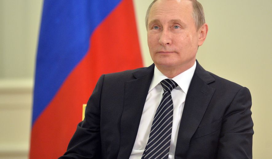Russian President Vladimir Putin looks at the opening ceremony of the first block of Kudamkulam nuclear power plant during a live video link with India, in Moscow's Kremlin, Russia on Wednesday, Aug. 10, 2016. (Alexei Druzhinin/Sputnik, Kremlin Pool Photo via AP)
