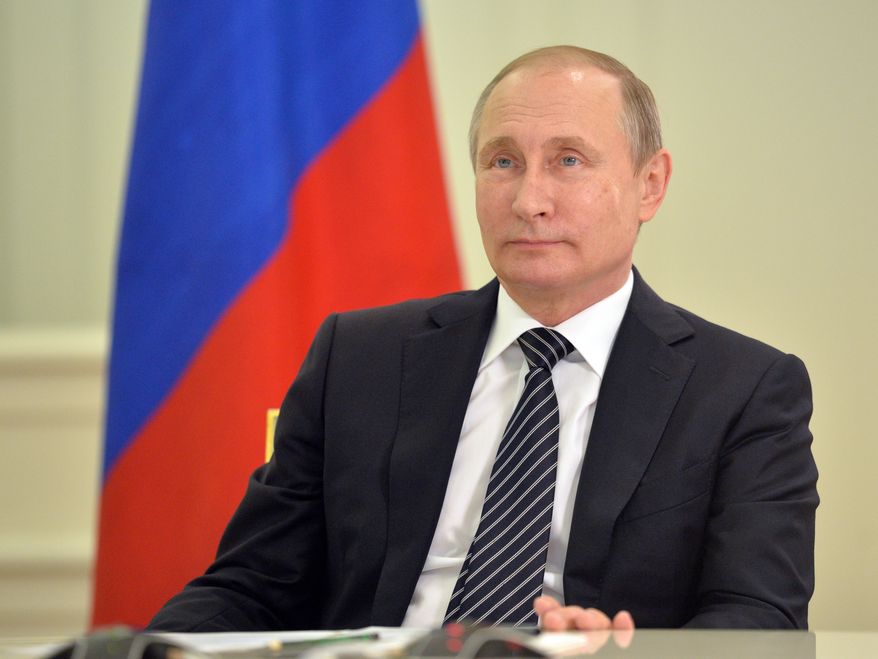 Russian President Vladimir Putin looks at the opening ceremony of the first block of Kudamkulam nuclear power plant during a live video link with India, in Moscow's Kremlin, Russia on Wednesday, Aug. 10, 2016. (Alexei Druzhinin/Sputnik, Kremlin Pool Photo via AP)