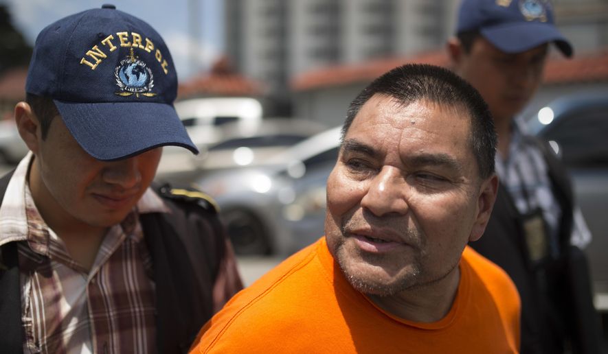 Santos Lopez Alonzo is escorted by Interpol agents after landing at the Air Force base in Guatemala City, Wednesday, Aug. 10, 2016. Lopez Alonzo, former Guatemalan soldier suspected of helping carry out a massacre of more than 160 people in 1982 during the country's civil war was deported from the United States on Wednesday after a court refused his plea to stay because he fears for his life. (AP Photo/Luis Soto)