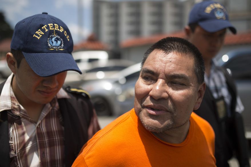 Santos Lopez Alonzo is escorted by Interpol agents after landing at the Air Force base in Guatemala City, Wednesday, Aug. 10, 2016. Lopez Alonzo, former Guatemalan soldier suspected of helping carry out a massacre of more than 160 people in 1982 during the country's civil war was deported from the United States on Wednesday after a court refused his plea to stay because he fears for his life. (AP Photo/Luis Soto)